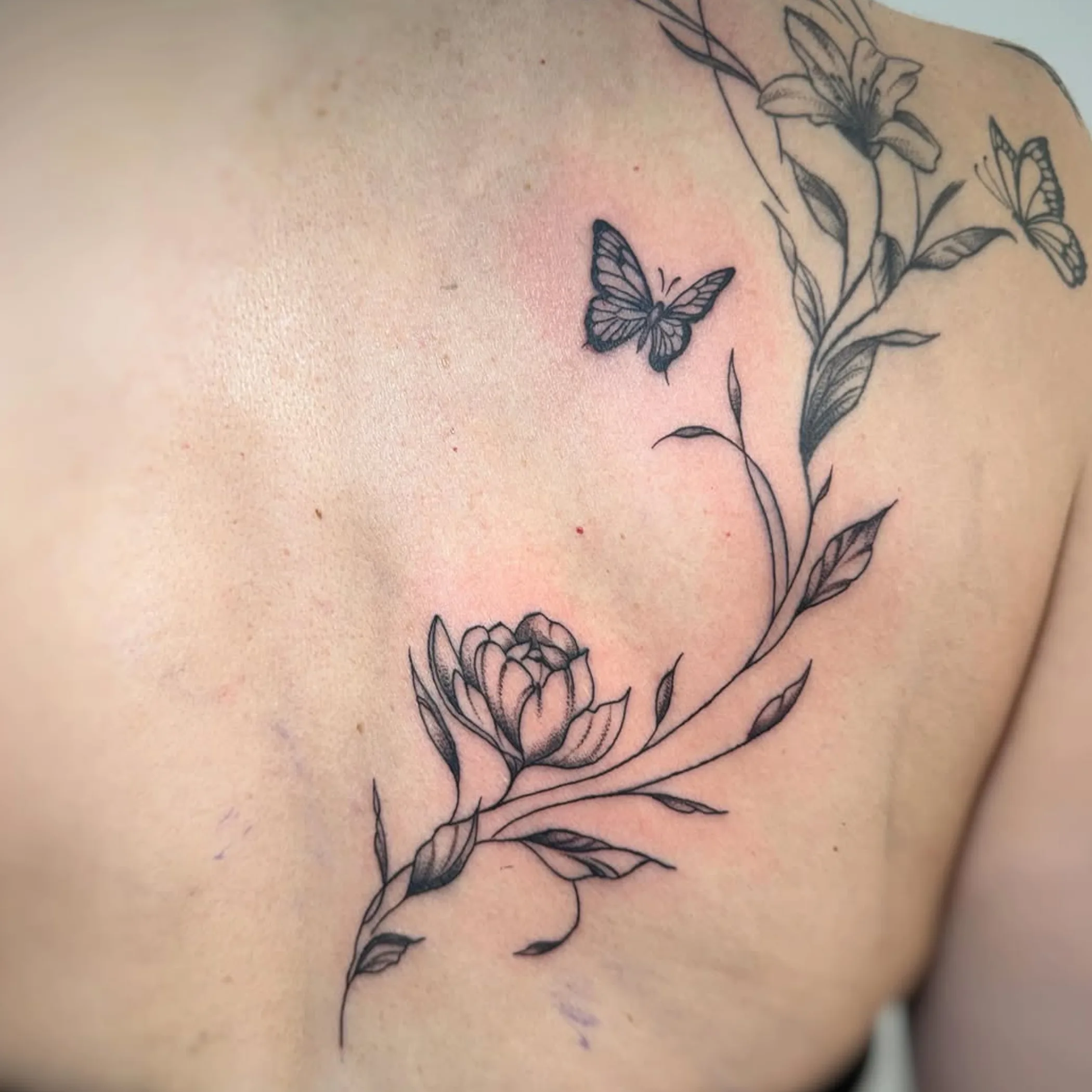 floral tattoo with butterfly motifs