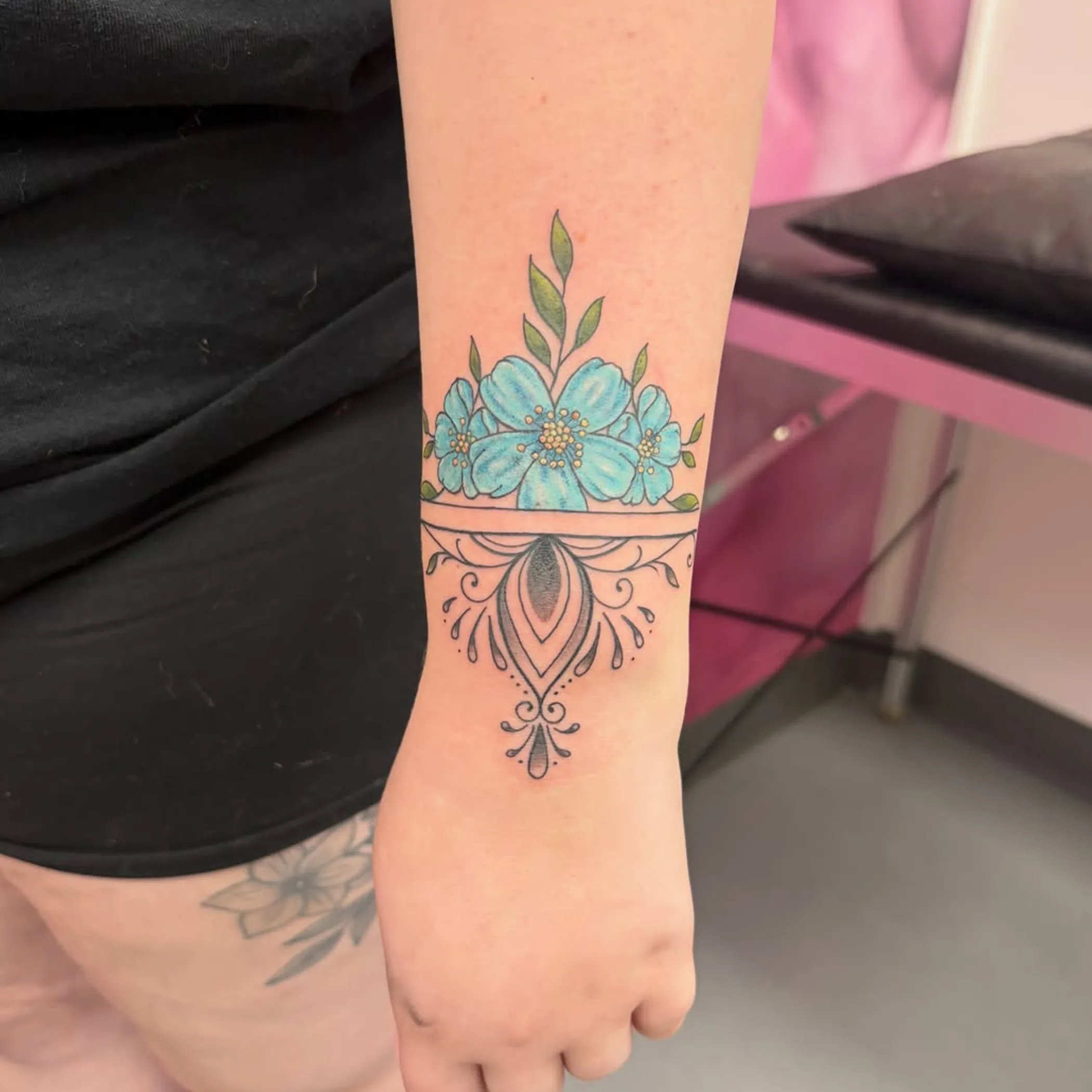 delicate floral wrist cuff tattoo