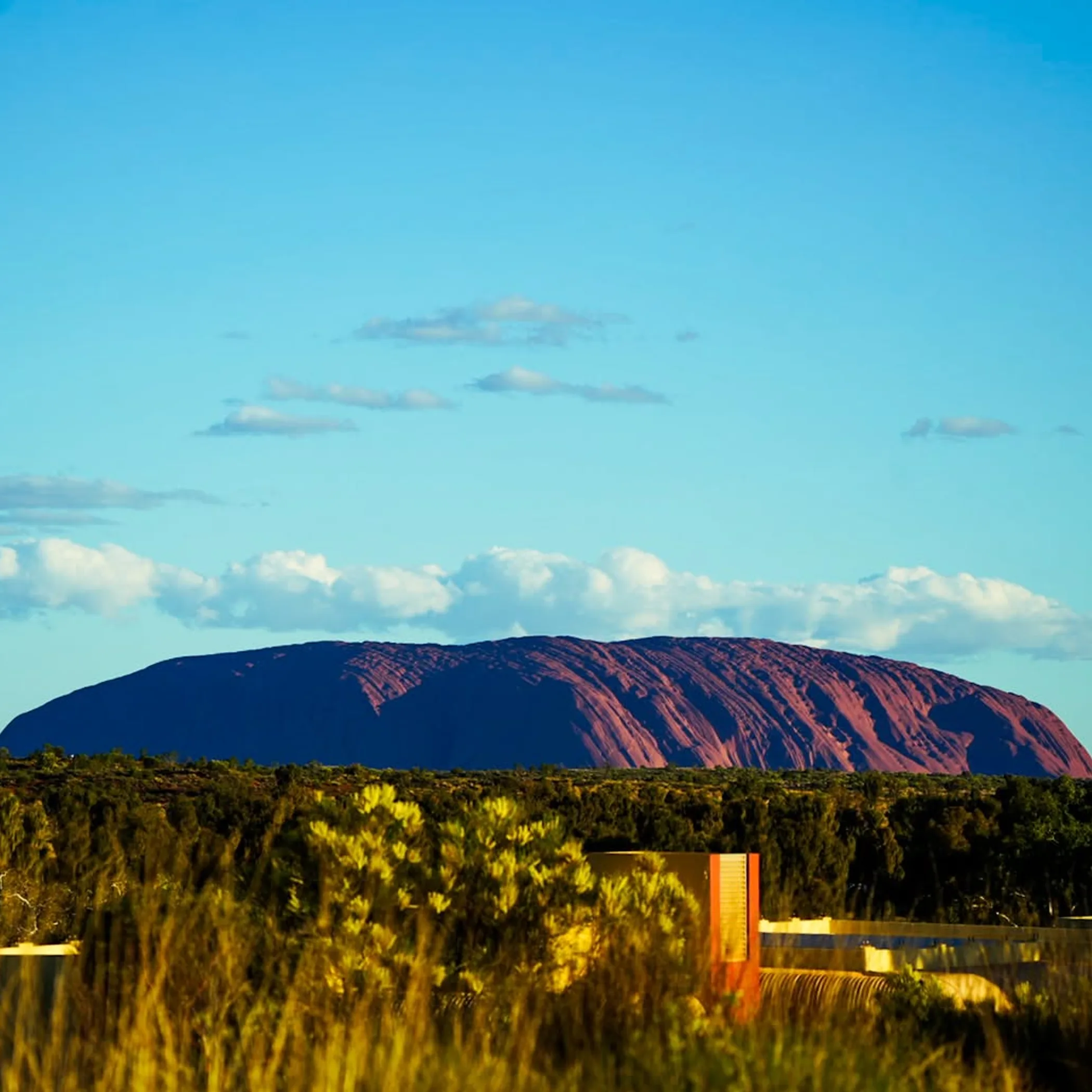 uluru in a well-lit photograph